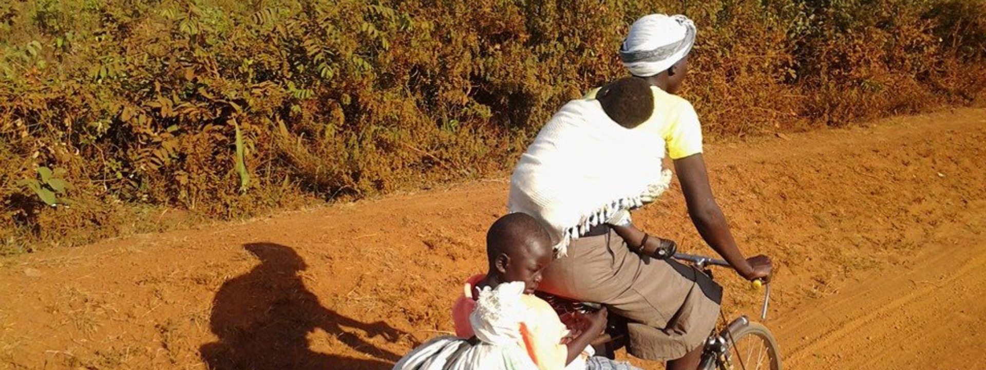Ugandan family on bike banner